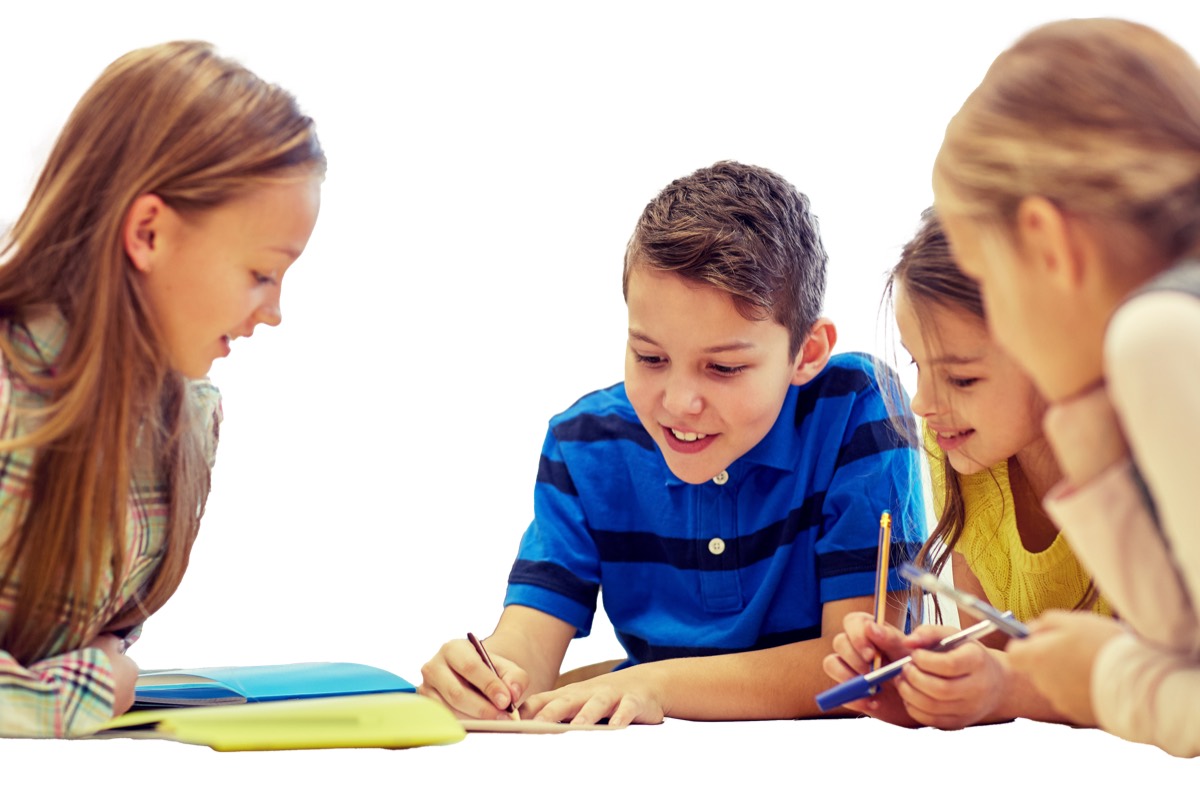 Children studying together and smiling